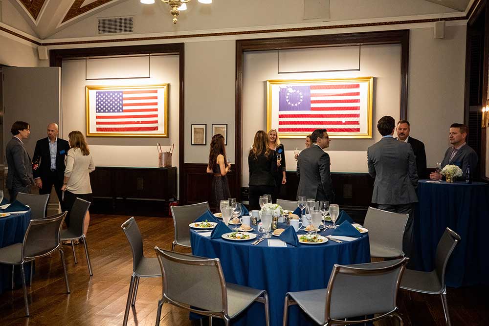 NYSE Dining Room with a set table and standing guests