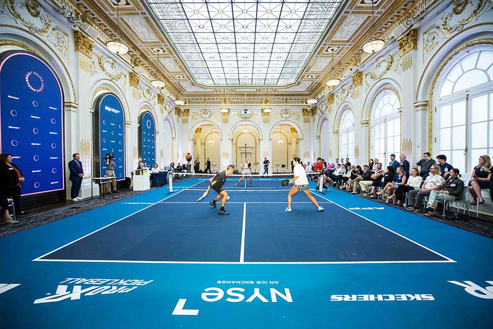 People playing pickleball in the NYSE Board Room